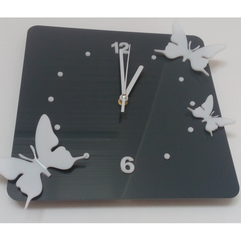 Modern wall clock made of plexiglass. Trendy clock on the wall as a gift. X-momo clocks. PMMA