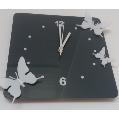 Modern wall clock made of plexiglass. Trendy clock on the wall as a gift. X-momo clocks. PMMA