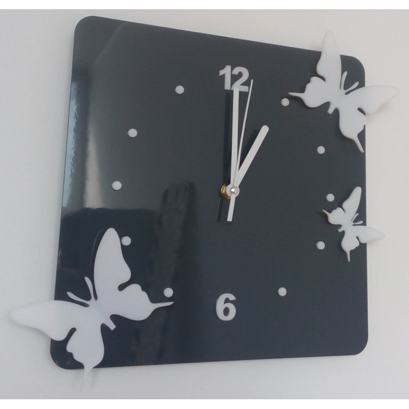 Modern wall clock made of plexiglass. Trendy clock on the wall as a gift. X-momo clocks. PMMA