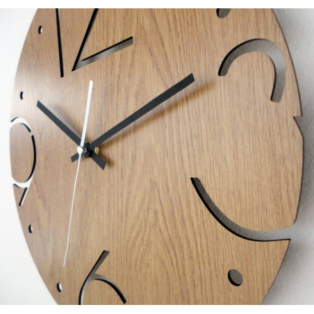 Wooden round clock with carved numbers 3, 6, 9 and 12 on a light oak base. Wooden round clock with carved numbers 3, 6, 9 and 12 on a light oak base.