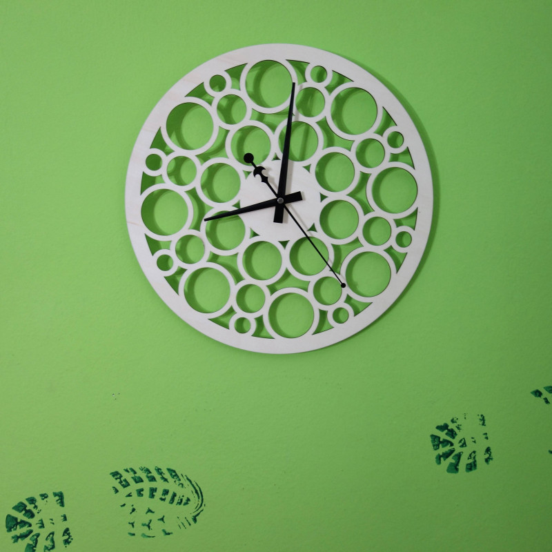 Wall clock made of wood plywood in the footsteps of time
