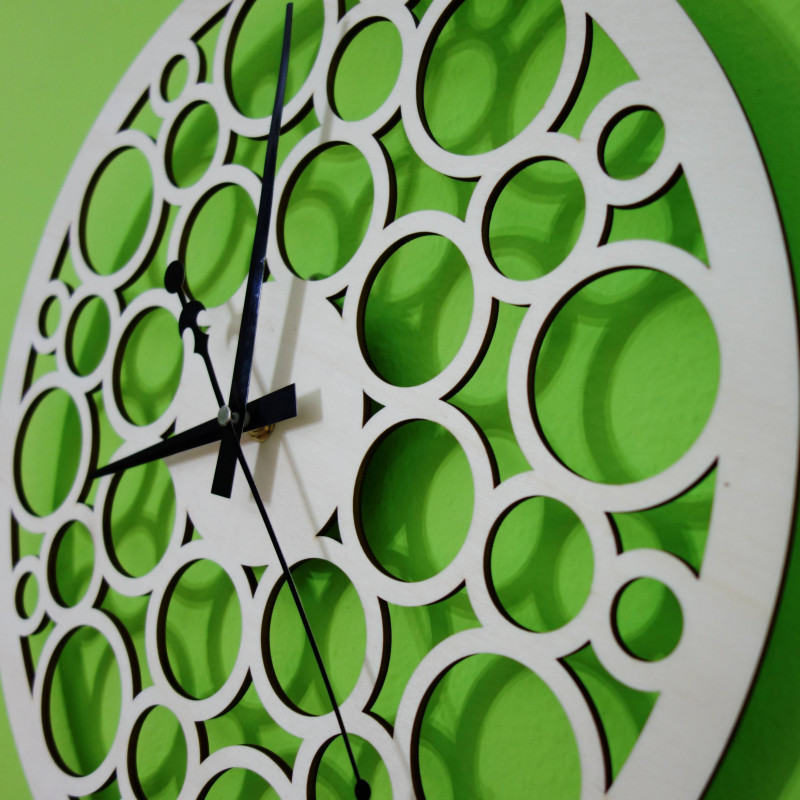 Wall clock made of wood plywood in the footsteps of time