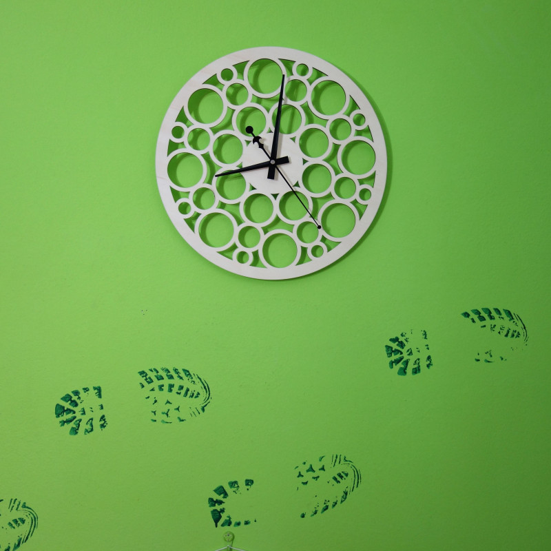 Wall clock made of wood plywood in the footsteps of time