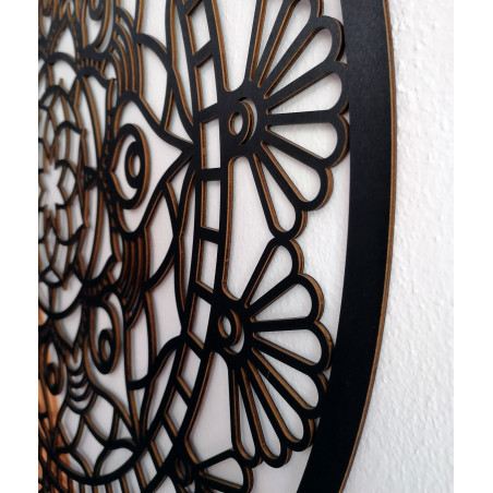 The mandala of life is rounded by a wooden picture on a wall made of SUSEN